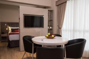 a room with a table with a bowl of fruit on it at ARC Arenales Studios & Suites in Buenos Aires