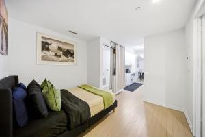 a bedroom with a couch in a white room at Spacious Condo with 2 Beds Unbeatable Location in Toronto