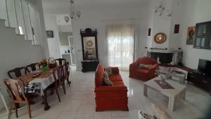 a living room with a table and a dining room at Georgia's Summer House in Karianí