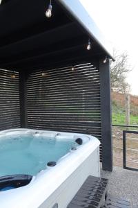 a jacuzzi tub in a black and white building at Galactic getaways PLUTO in Prestatyn