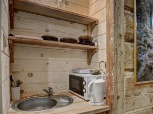 a kitchen with a sink and a microwave at Pokoje Gościnne Światłomir in Zakopane +60 photos
