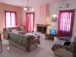 a living room with two couches and a fireplace at Giannad suite in Distomo
