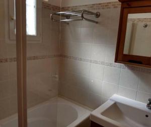 a bathroom with a tub and a sink and a shower at Villa T3 avec piscine in Sollacaro