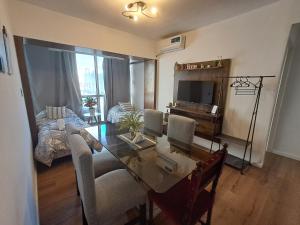 a living room with a dining table and a living room with a bed at C&MHouse in Buenos Aires +8 photos