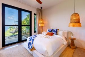 a bedroom with a bed and a large window at Villa Odyssea BVI in Tortola Island +143 photos