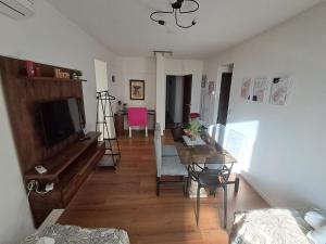a living room with a table and a dining room at C&MHouse in Buenos Aires