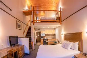 a bedroom with a bed and a loft at The Rundlestone Lodge in Banff +83 photos
