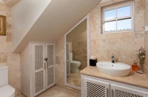 a bathroom with a sink and a toilet at Bianca Bay 3 Bedroom West Coast Beach Front Villa in Saint James +40 photos