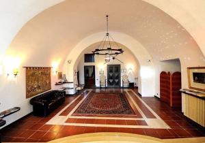 a large living room with a couch and a rug at Palazzo Ducale Sangiovanni in Alessano