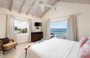 a bedroom with a bed and a view of the ocean at Bianca Bay 3 Bedroom West Coast Beach Front Villa in Saint James