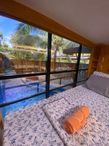 a bed in a room with a view of a pool at Journeyy INN in General Luna