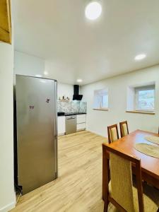 a kitchen and dining room with a stainless steel refrigerator at Casa Alma Serena in Batalha