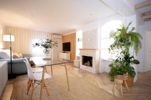 a living room with a table and a fireplace at Douro Rural Home in Melres
