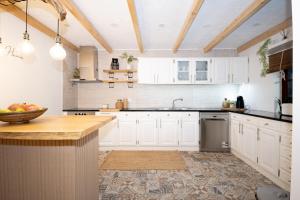 a kitchen with white cabinets and a counter top at Douro Rural Home in Melres