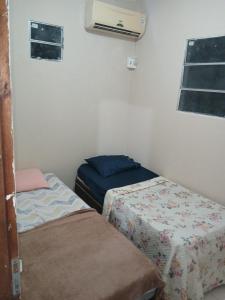 a small room with two beds and a air conditioner at River House in Marau