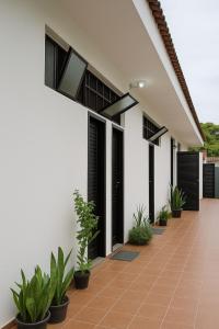 an external view of a house with plants at Suítes Praia dos Sonhos in Itanhaém