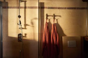 two red umbrellas hanging on a wall at L'Ecurie Former stable with charm and light in Ingrandes +7 photos