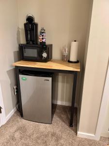 a small refrigerator under a table with a microwave at Killington Center 131 in Killington