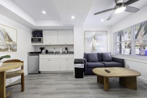 a living room with a couch and a table at Siesta Key Beach Resort and Suites in Sarasota