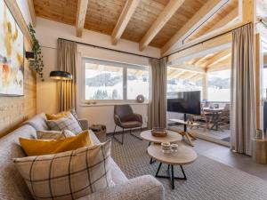 a living room with a couch and a table at Alpenchalet Lambert in Sankt Lambrecht