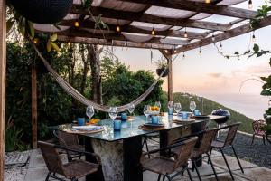 a table on a patio with a view of the ocean at Villa Odyssea BVI in Tortola Island