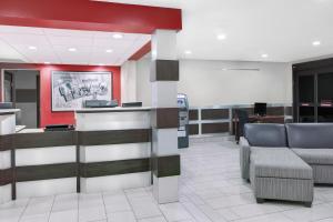 a waiting room with chairs and a cash register at Super 8 by Wyndham Bedford DFW Airport West in Bedford
