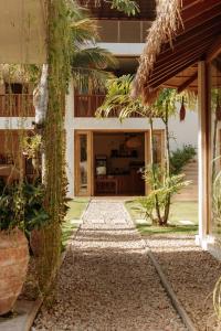 an entrance to a house with a pathway at Meraki in Polhena
