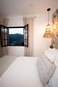 a bedroom with a bed and a large window at Douro Rural Home in Melres +40 photos