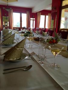 a long table with wine glasses and plates on it at Tavel boutique hotel in Prešov