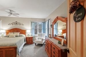 a bedroom with a bed and a mirror and a chair at Paper Mill Pines Bed and Breakfast in Shickshinny