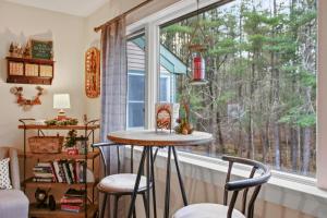 a kitchen with a table and chairs in front of a window at Paper Mill Pines Bed and Breakfast in Shickshinny