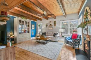 a living room with blue walls and a wooden ceiling at Paper Mill Pines Bed and Breakfast in Shickshinny