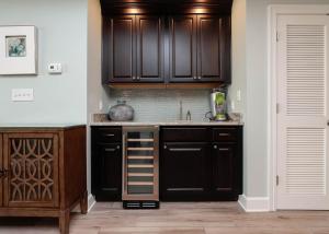 a kitchen with dark brown cabinets and a sink at Phoenix Gulf Shores 903 in Gulf Shores