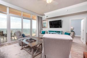 a living room with a couch and a table at Phoenix Gulf Shores 903 in Gulf Shores +25 photos