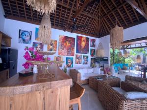 a living room with a lot of pictures on the wall at Villa Dunia - 400M Private Villa Walk to Beach Top location Gili Trawangan in Gili Trawangan +32 photos