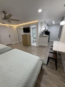 a bedroom with a bed and a living room at Renovated Beachfront Studio, New Kitchen, Pool in Daytona Beach