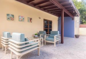 a group of chairs sitting on a patio at Luce del sole in Oranjestad