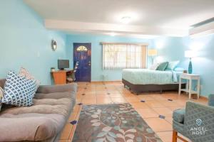 a living room with a couch and a bed at Great cozy place near Malecón in La Paz