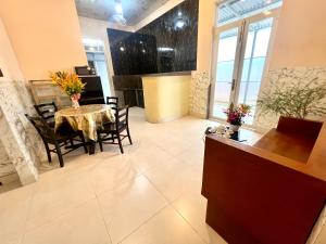 a dining room with a table and chairs in a room at Khách Sạn Homestay LaMera in Ben Tre