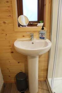 a bathroom with a sink and a mirror at Sea Crest Pods Rossnowlagh Donegal in Rossnowlagh