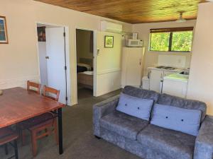 a living room with a couch and a table at Judges Pool Motel Turangi in Turangi
