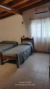 a bedroom with two beds and a window at Depto Nacho in San Antonio Oeste