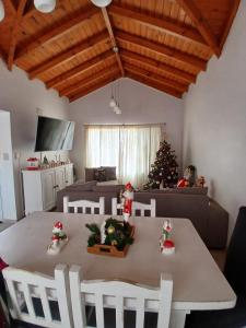 a dining table with a christmas tree in a living room at Chiche del mar in Playa Unión