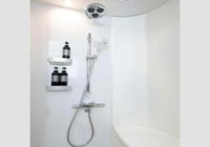a bathroom with a shower with a shower head at Hotel Opera in Tokyo