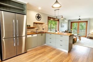 a kitchen with stainless steel appliances and wood floors at Buffalo Bliss in Porepunkah