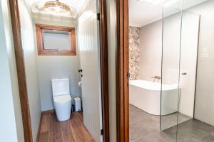 a bathroom with a toilet and a sink at Buffalo Bliss in Porepunkah +23 photos