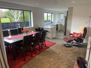 a dining room and kitchen with a table and chairs at Red Tussock Motel in Te Anau