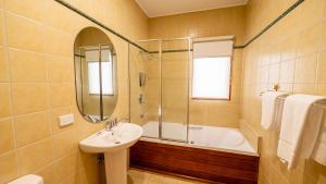 a bathroom with a sink and a bath tub and a sink at Camelot in Dinner Plain +35 photos