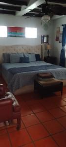 a bedroom with a large bed with blue pillows at Summer Nights Oceanfront Villa - Pool & Jacuzzi in Primo Tapia +18 photos