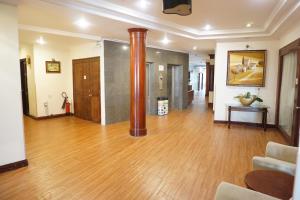 a living room with a wooden floor and a pole at Dong Khanh Hotel in Ho Chi Minh City